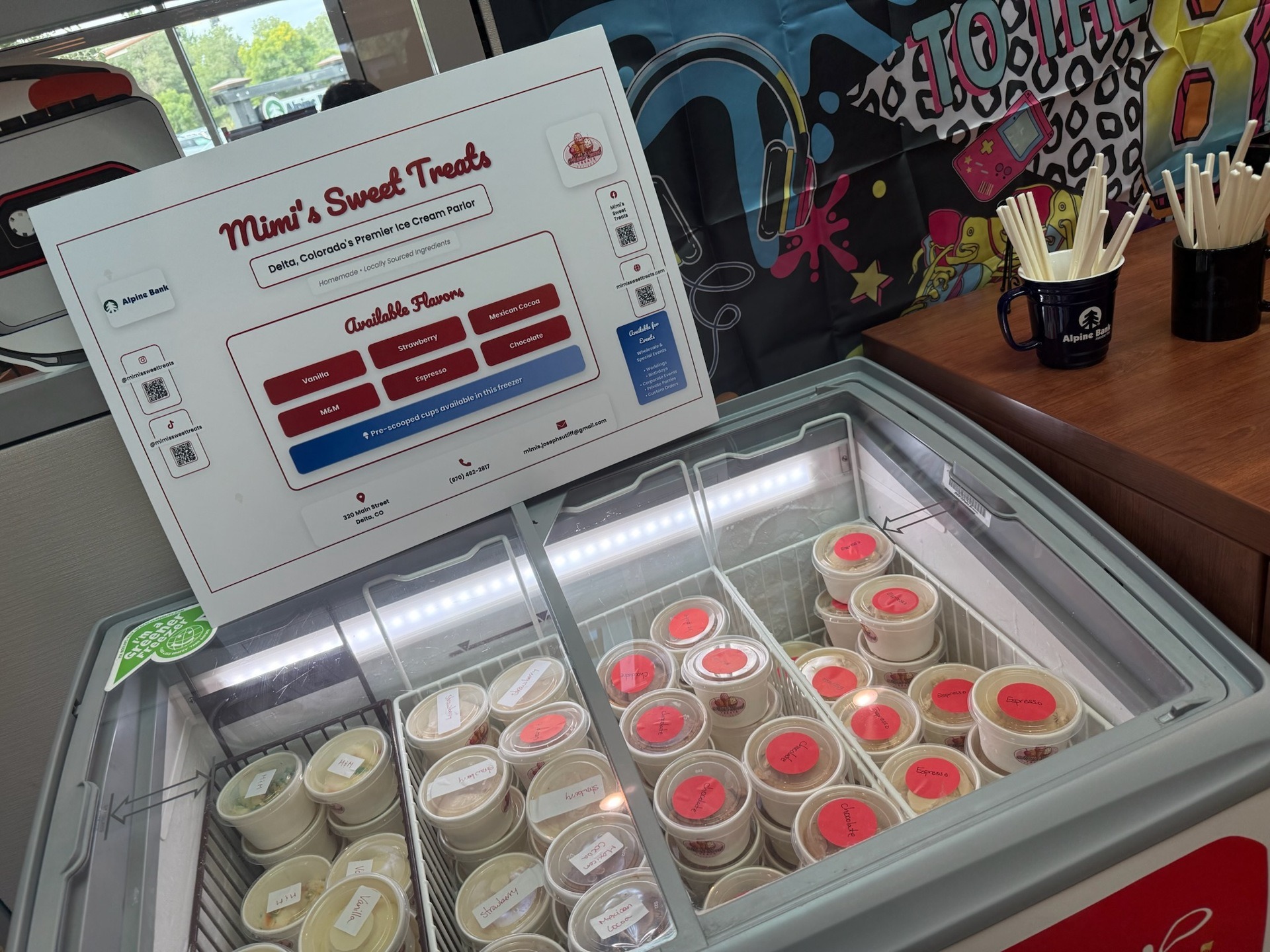 Mimi's Sweet Treats branded freezer display case at a community market event